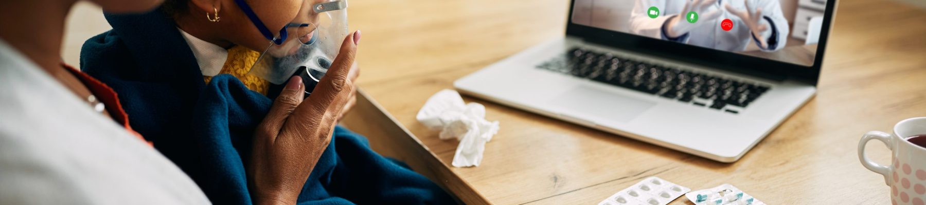 African American family doctor explaining online the procedure of inhaling therapy to mother and daughter at home during coronavirus pandemic.